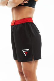 Woman wearing black and red Fighters Choice Everlasting Fight Shorts, with the Fighters Choice logo on the left leg pant, the apparel elite fighters use to look sharp on the BJJ mat