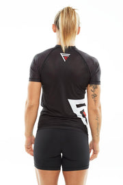 Woman showing her back while wearing black Fighters Choice Takeover Short Sleeve Rashguard, the best rashguard for both men and women, Gi/NoGi BJJ fighters