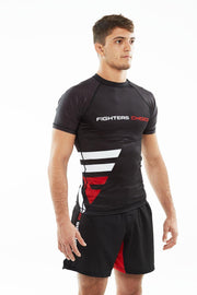 Man wearing black Fighters Choice Takeover Short Sleeve Rashguard, with the Fighters Choice name and prominent logo on the front, the best apparel for Gi/NoGi BJJ fighters