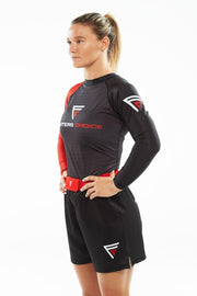 Woman with hands on waist, wearing Fighters Choice Gi/NoGi Bloody Arm Long Sleeve Rashguard for Men, Women and BJJ Fighters